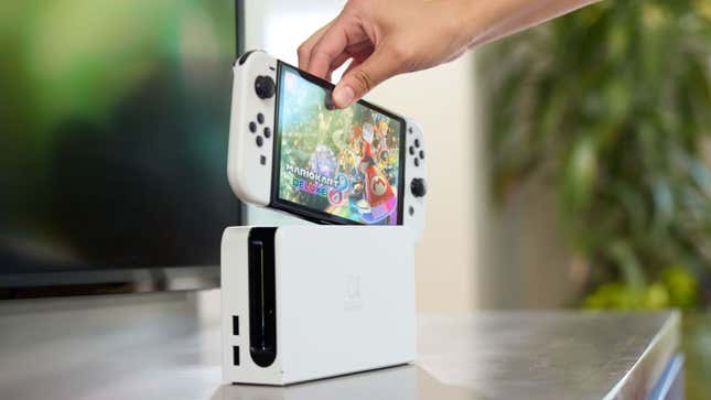 A Switch OLED being put into its dock.