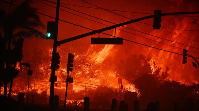 A fire burns in the background of an LA street. 